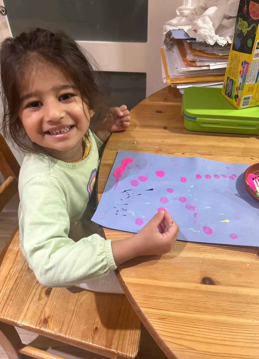 Photo of daycare kid creating finger art